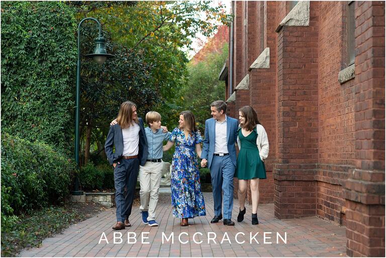 Candid image of a family walking along a red brick sidewalk in Uptown Charlotte