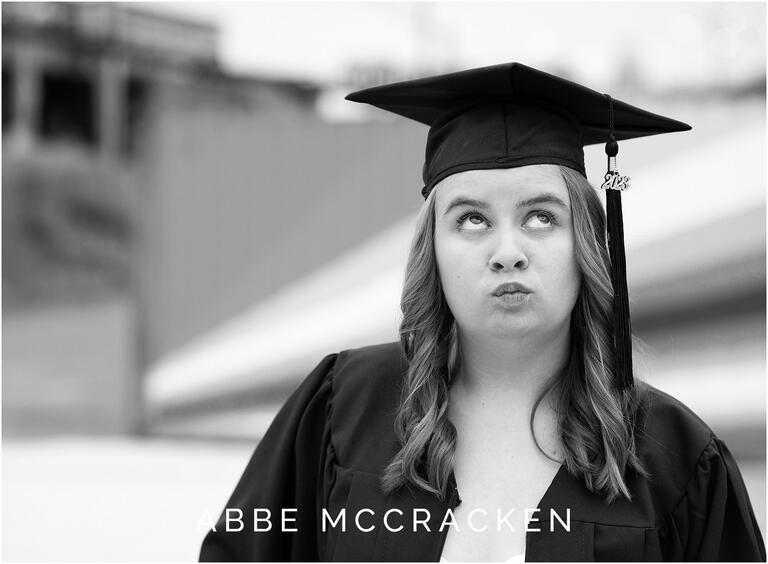 Senior girl makes silly face in black and white for graduation photos at Camp North End, 2023 Graduate