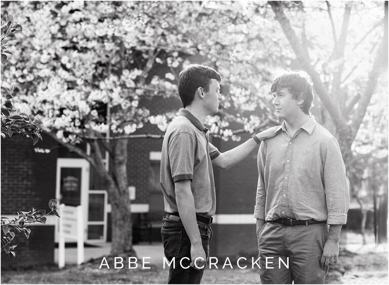 Brothers in front of spring blooms, black and white