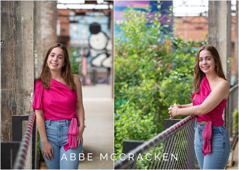 high school grad leans on railing and wears pink shirt at senior portraits