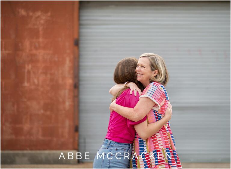 Daughter and mother hugging at senior portrait session
