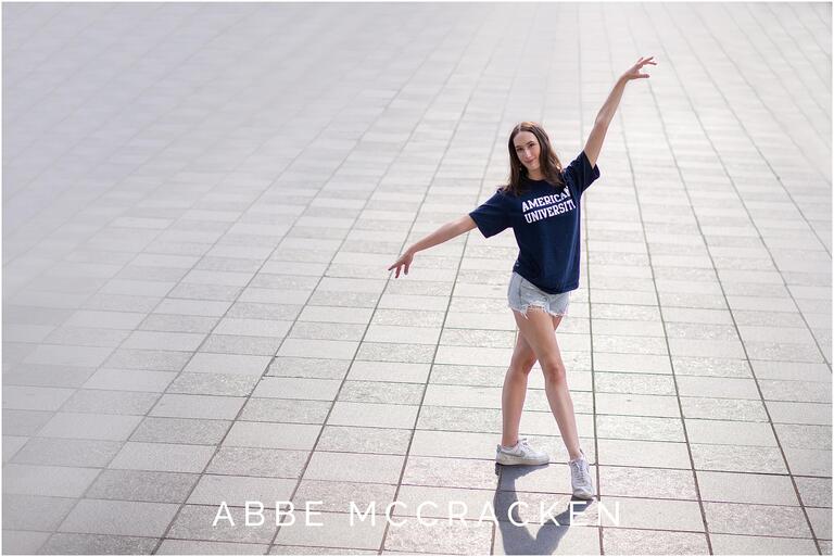Portrait of a Charlotte Ballet Dancer striking a pose while wearing her American University t-shirt