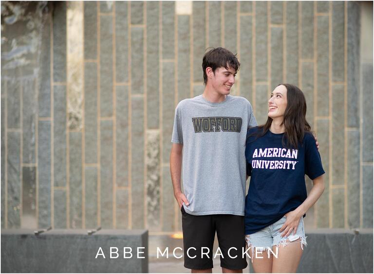 Twin high school graduates photographed wearing their college t-shirts