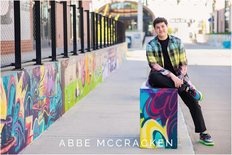 Casual senior portrait with lots of colorful art and murals, Camp North End