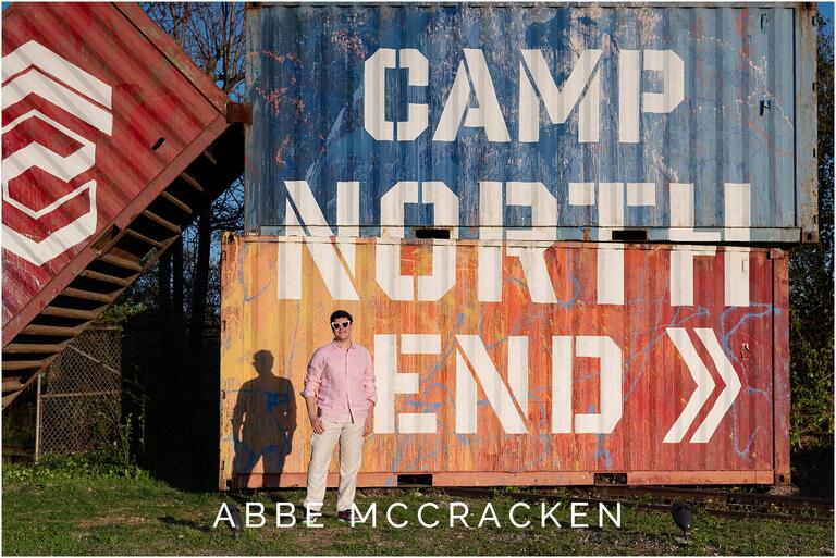 Portrait of a high school graduate near the Camp North End container sign