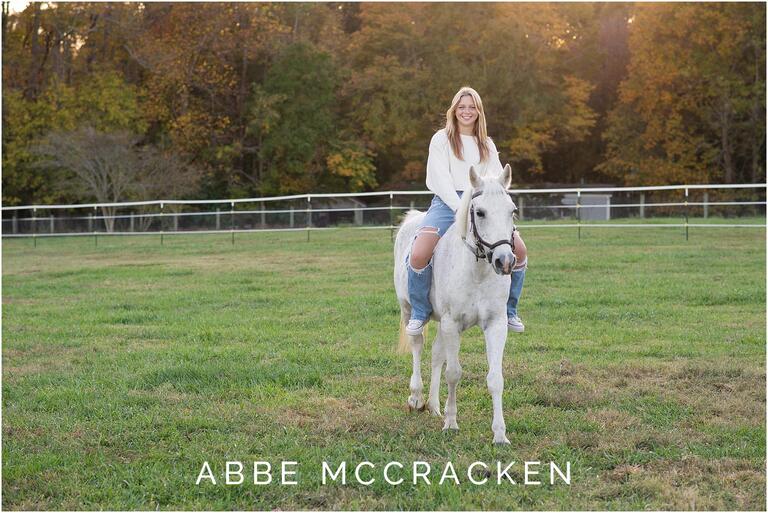 Senior portraits riding a white horse at Old Frankfort Farm and Stables