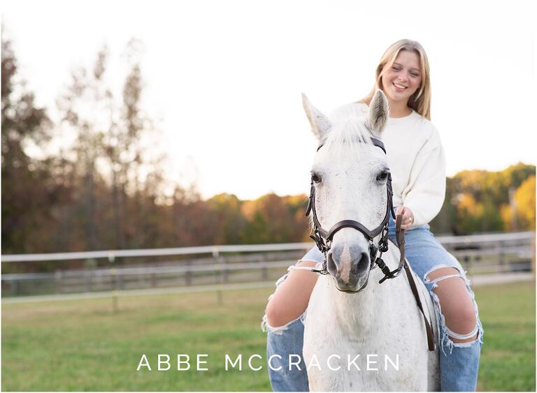 Senior portraits riding a white horse at Old Frankfort Farm and Stables