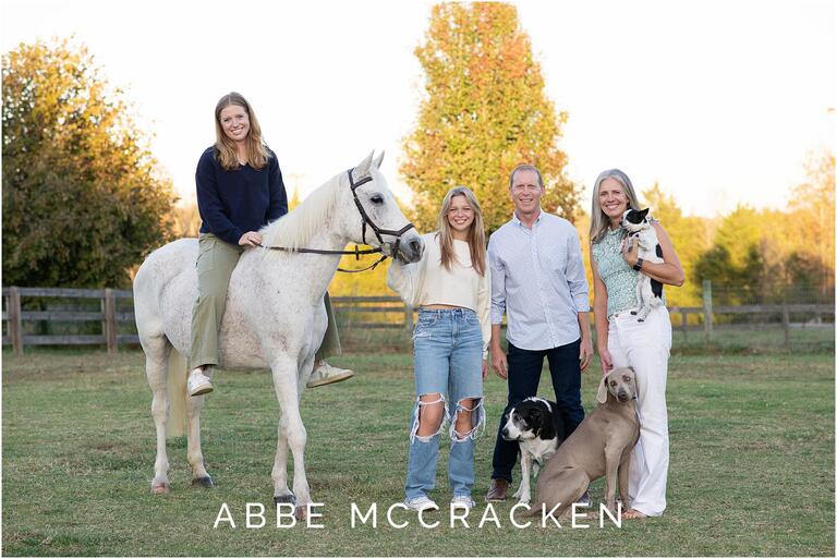 Family portrait at Old Frankfort Farm with dogs and horses