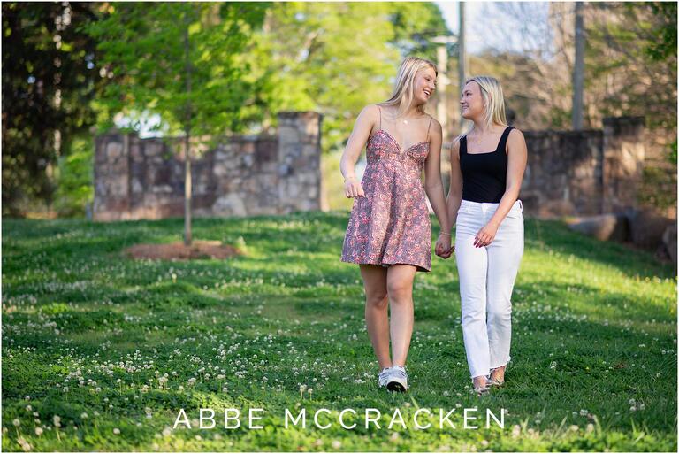 High school seniors and best friends walking hand in hand in the park