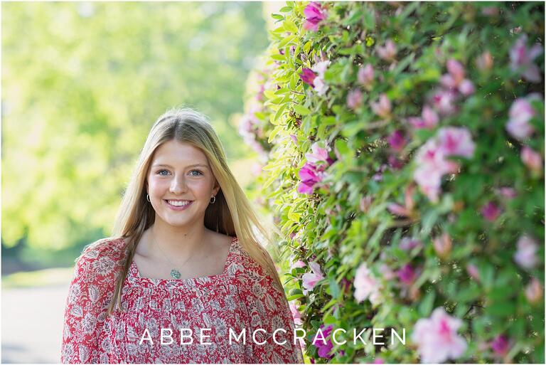 Senior portrait with purple azaleas in bloom