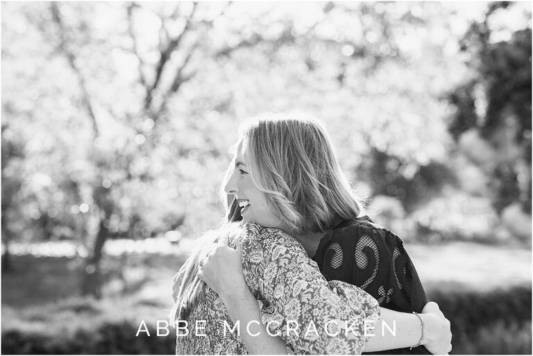 black and white image of a mother hugging her daughter during senior portrait session