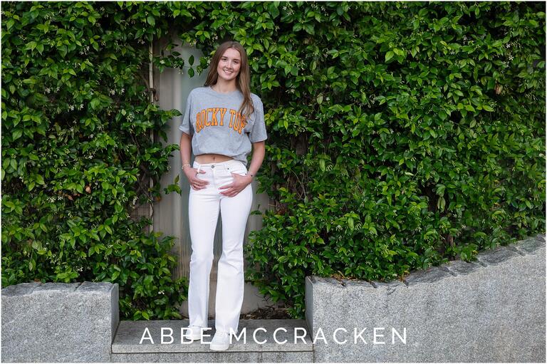 Senior portrait in Romare Bearden Park in Uptown Charlotte wearing Tennessee shirt