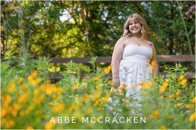 Senior portrait with yellow and purple flowers, Marvin Efird Park