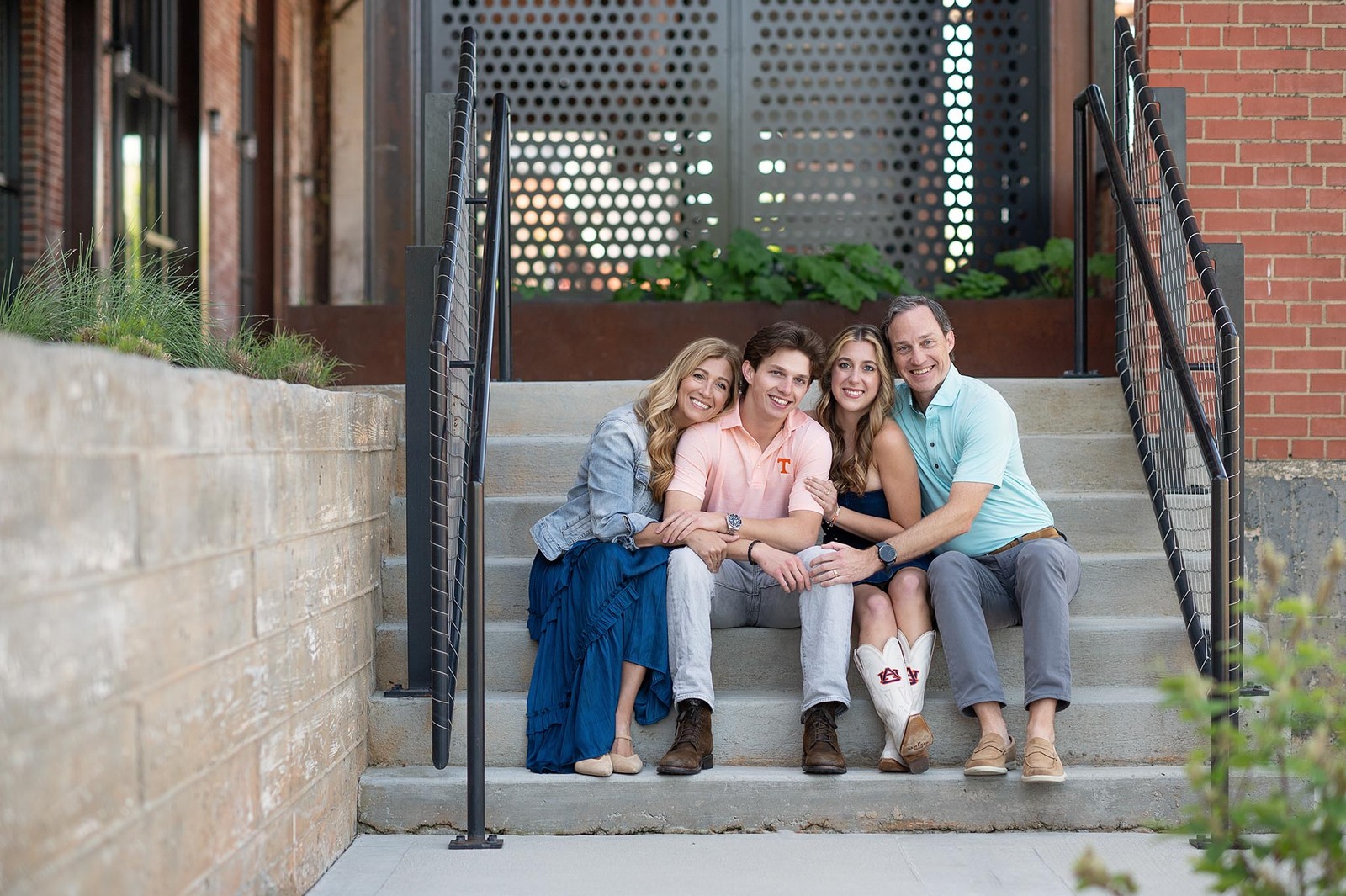 Parents and high school seniors hugging on steps and Camp North End